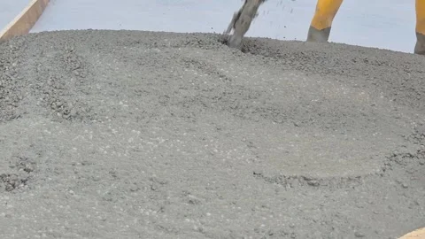 Construction workers pouring and shaping slope forming concrete Stock Footage 337847576