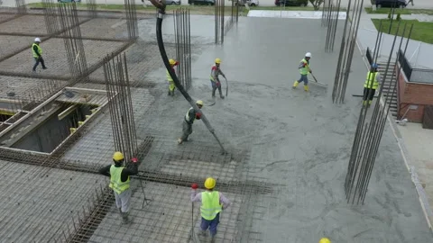 Construction Workers Pouring And Spreading Concrete Mix During Slab Video stock 163196629