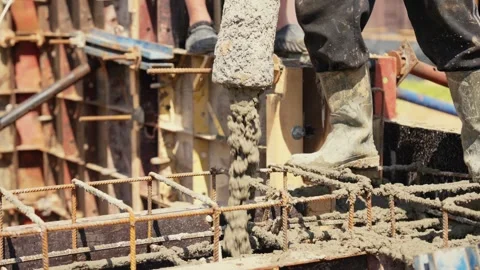 Construction workers pouring concrete into formwork Stock Footage 341294766