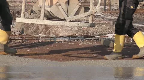 Construction workers pouring concrete for a foundation Stock Footage 22001292