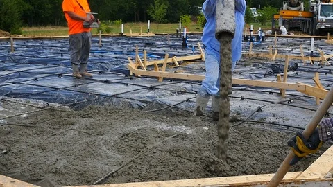 Construction workers pouring a concrete foundation Stock Footage