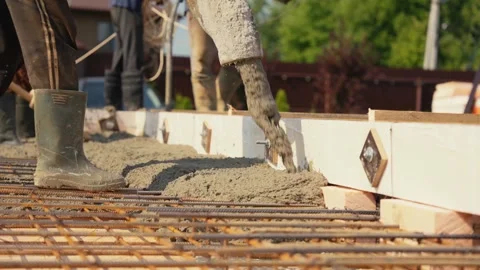 Construction workers pouring concrete foundation for house Stock Footage 341294339