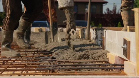 Construction workers pouring concrete for house foundation Stock Footage 341294375