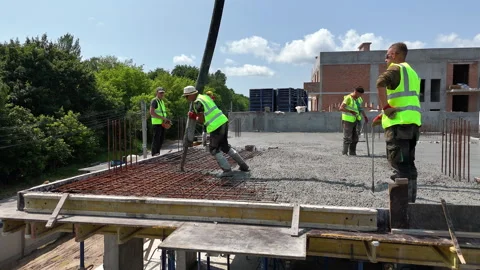 Construction workers pouring concrete on reinforced floor slab, High-rise Stock Footage 311076475