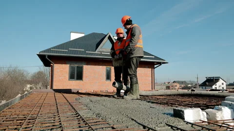 Construction workers pouring concrete slab on rebar mesh, Building foundation Stock Footage 309228196