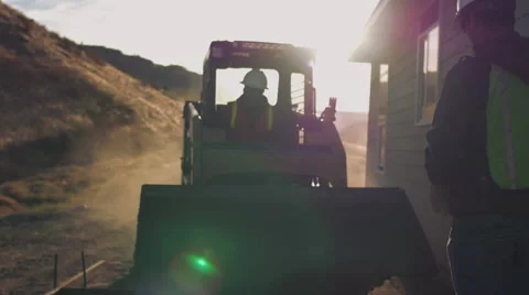 Construction workers pouring concrete with sun flare Stock Footage 55171181