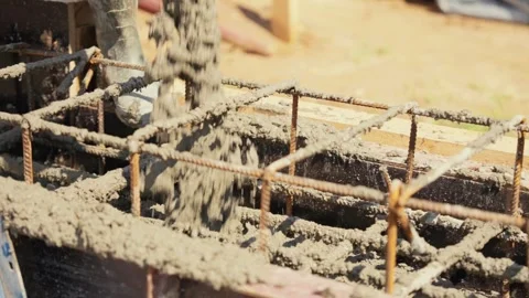 Construction workers pouring liquid concrete into foundation formwork Stock Footage 341294776