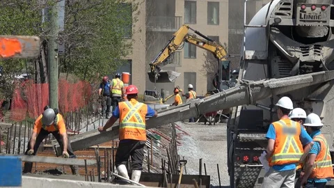 Construction workers pouring , mixing cement and concrete Stock-Footage 89817372