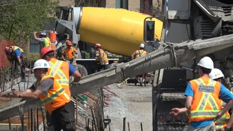 Construction workers pouring , mixing cement and concrete Stock Footage