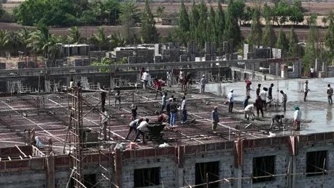Construction Workers Preparing Concrete Slab on Unfinished Building Framework Stock Footage 344477626