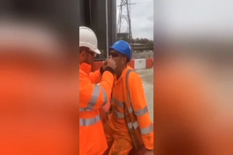 Construction workers pull colleagues tooth with string Stock Footage 109261958