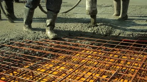 Construction workers pulling large hose for concreting slab. Tracking shot. Stock Footage 47315403