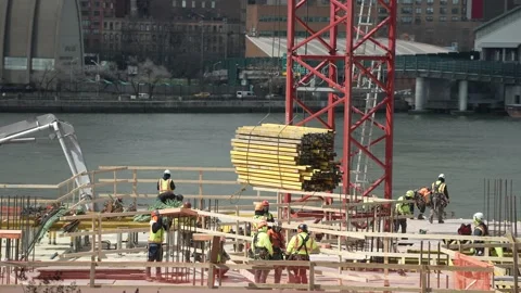 Construction workers pulling yellow palette Stock Footage 241451346