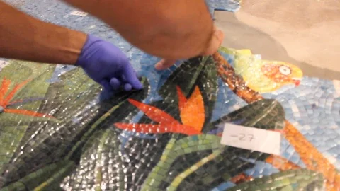 Construction workers put together mosaic tiles on the floor B Stock Footage 125057123