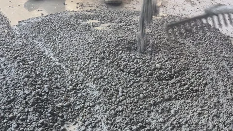 Construction Workers Raking Coarse Aggregate Concrete for Slope Stock Footage 341731154