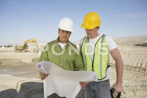 Construction Workers Reading Blueprints Stock Photos