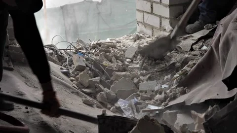 Construction workers remove construction debris with shovels close-up Stock Footage 217374086