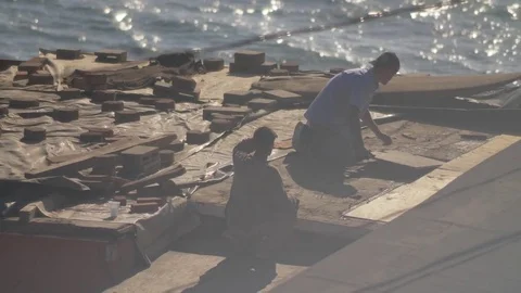 Construction workers repair roof in developing nation, slo-mo. Stock Footage 82329943