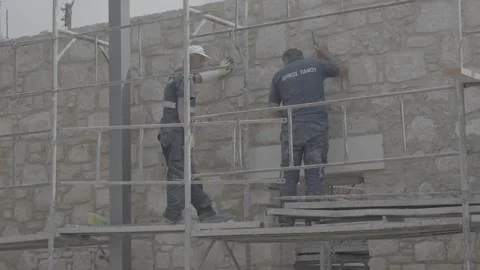 Construction workers repairing a building in Paphos, Cyprus Stock Footage 344056705