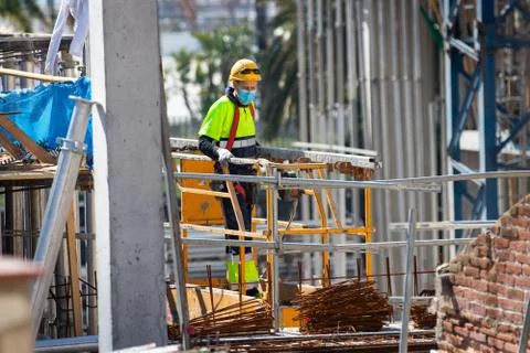 Construction workers return to work with masks protected against Covid-19. Stock Photos