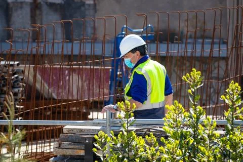 Construction workers return to work with masks protected against Covid-19. Stock Photos