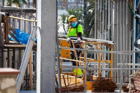 Construction workers return to work with masks protected against Covid-19. Stock Photos