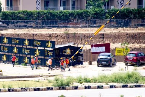 Construction workers returning to a real estate development project as the re Stock Photos