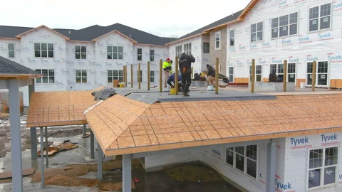 Construction workers on roof Stock Footage 228489062