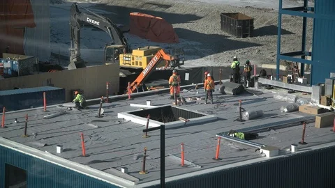 Construction workers on rooftop in winter Stock Footage 100034220