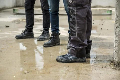 Construction workers in safety clothes standing on construction site. 스톡 사진