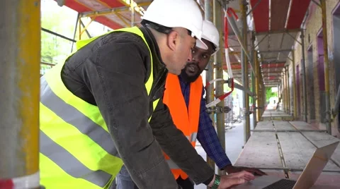 Construction workers with safety jacket and helmet at computer. Tracking shot 動画素材 62527037