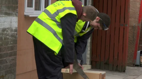 Construction workers sawing wood Stock Footage 30451304