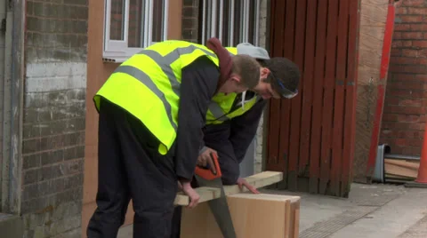Construction workers sawing wood Stock Footage 30451357
