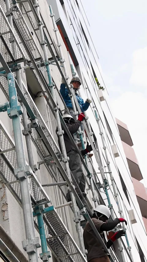 Construction Workers on Scaffolding During Building Renovation in Tokyo Stock Footage 343837179