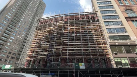 Construction workers scaffolding in hardhat renovating building in Manhattan NYC Stock-Footage 159732552