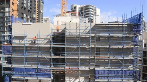 Construction workers on scaffolds building high-rise house as timelapse in 4k. Stock Footage 143623479
