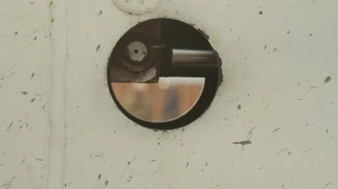 Construction workers seen through metal hole rack focus Stock Footage 21557401