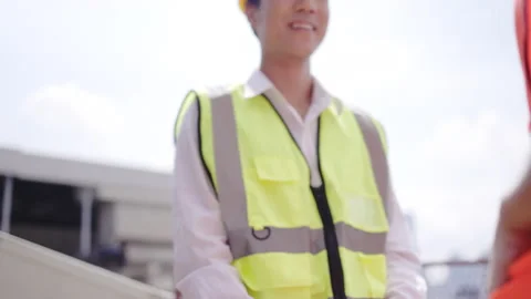 Construction workers shake hands congratulating work success. Stock Footage 158811301
