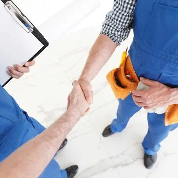 Construction workers shaking hands Stock Photos