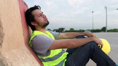 Construction workers sit and relax after exhausting work Stock Footage 159772302