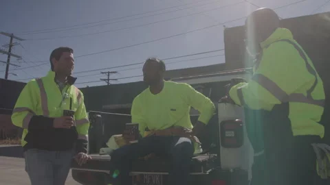 Construction Workers Sit In Back Of Truck Talking On Work Break Stock Footage 270389735