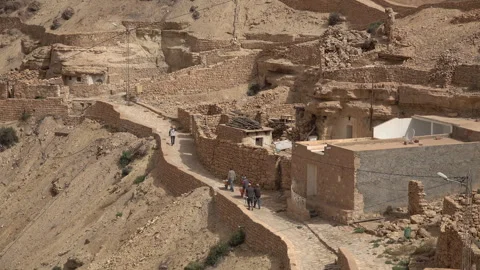 Construction workers in small Berber village of Takrouna in Tunisia Stock Footage 303499703