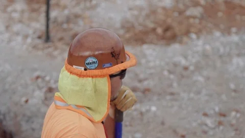 Construction Workers Spread Gravel Out Inside A Trench Stock Footage 87482233