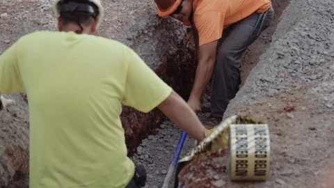 Construction Workers Spread Gravel Out Inside A Trench Stock Footage 87482296