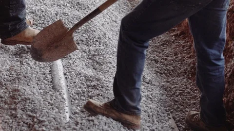 Construction Workers Spread Gravel Out Inside A Trench 스톡 동영상 87482884