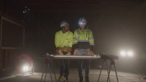 Construction Workers Stand Talking Over Work At Table At Night Stock-Footage 270390776