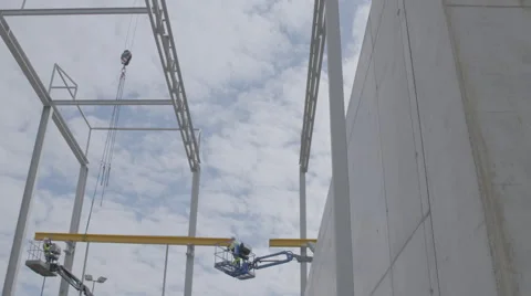 Construction workers standing on a skylift Stock Footage 64550282
