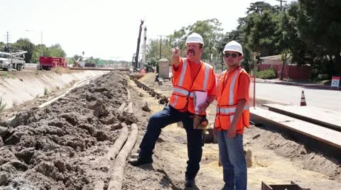 Construction workers survey work site Stock Footage 11840744