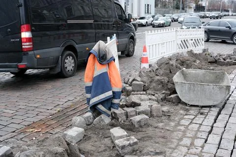 Construction workers take a break on a busy city street Stock Photos