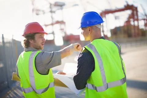 Construction workers talking on site Stock Photos